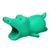 a green crocodile toy with its mouth open