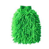 a green mop with a handle on it
