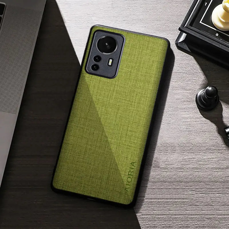 the back of a green iphone case on a desk