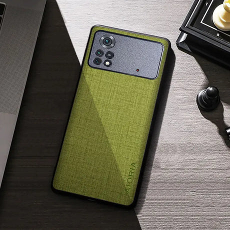the back of a green iphone case on a desk