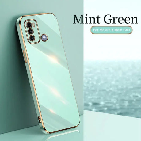 the mint green iphone case is shown on a table