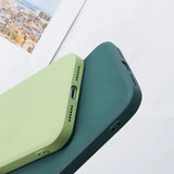 the back of a green iphone case on a white table