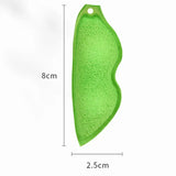 a green leaf shaped pendant with a white background
