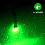 a green light shining through the water droplets