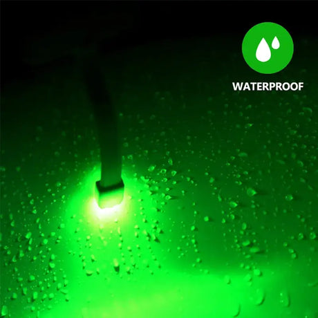 A green light shining through the water droplets