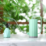 a green watering watering system on a table
