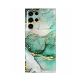 a close up of a green and gold marble phone case