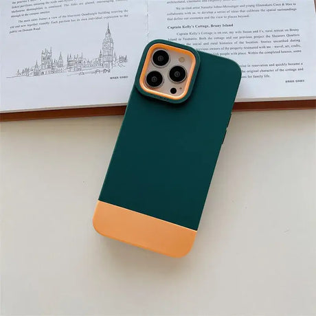 The green and orange iphone case is on a table