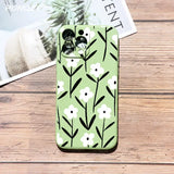 a green phone case with black and white flowers
