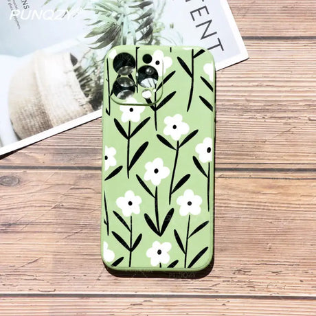 A green phone case with black and white flowers