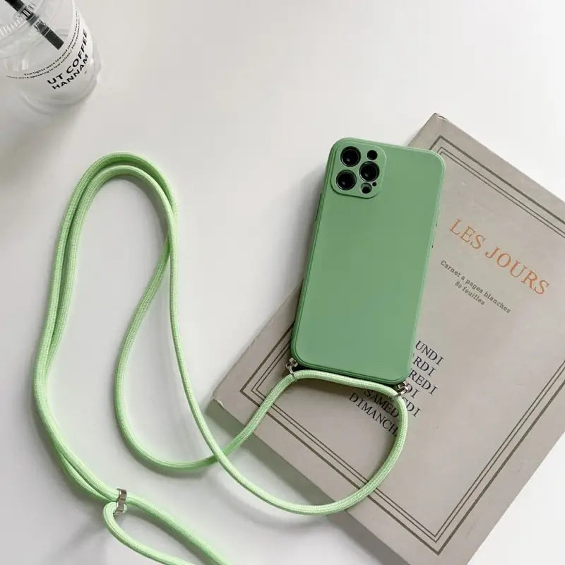 there is a green phone case with a lanyard attached to it