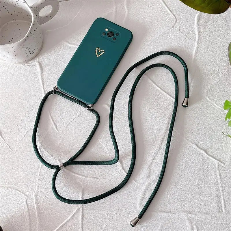the green phone case is attached to a strap