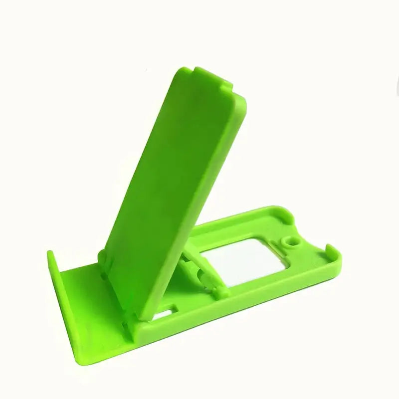 a green plastic phone stand with a white background