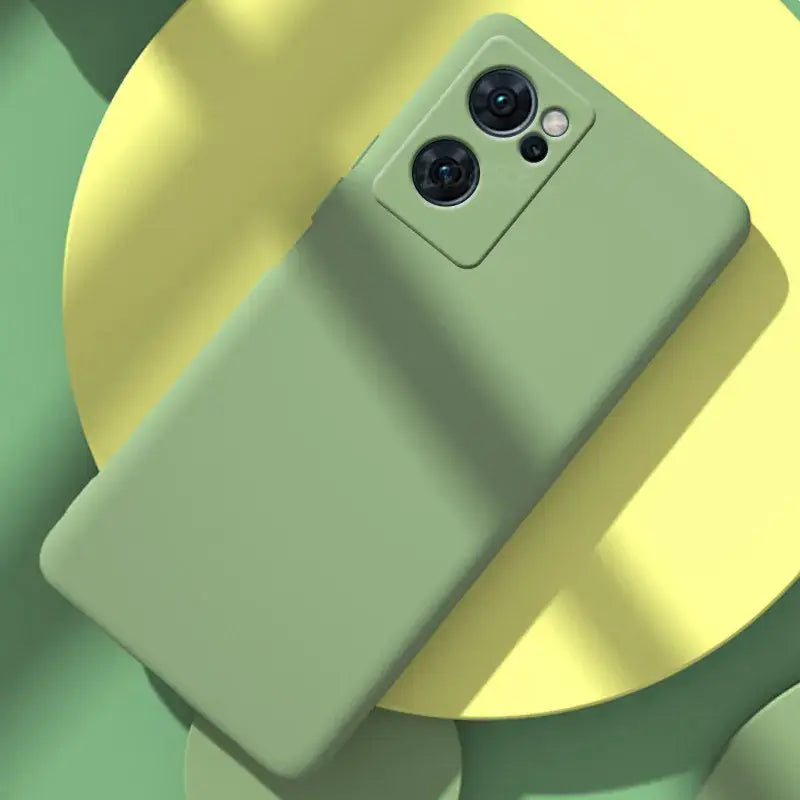 the back of a green phone with a yellow background