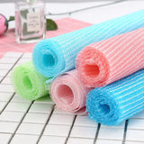 three rolls of colorful colored bath towels on a white surface