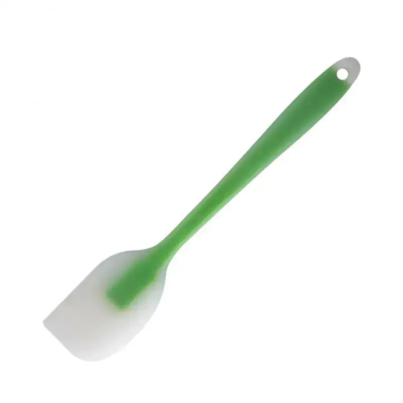 a green plastic spat with a white handle