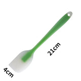 a green plastic spat with a white handle