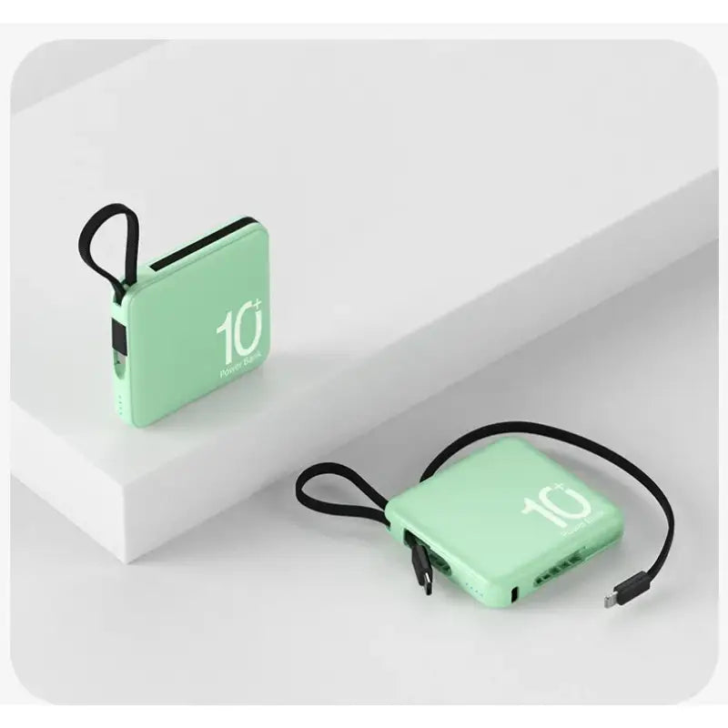 a green power bank with a black cord