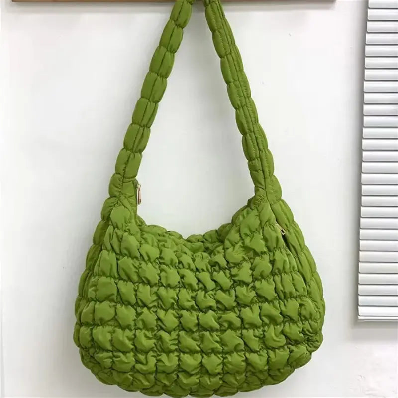 a green purse hanging on a wall