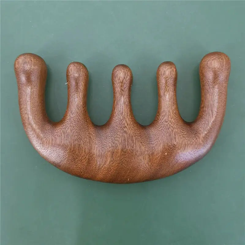a wooden handle with three claws on it