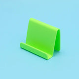 a green plastic stand on a blue background