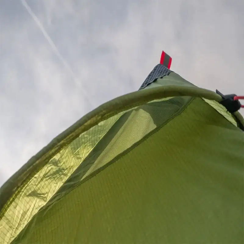 a green tent with a red handle