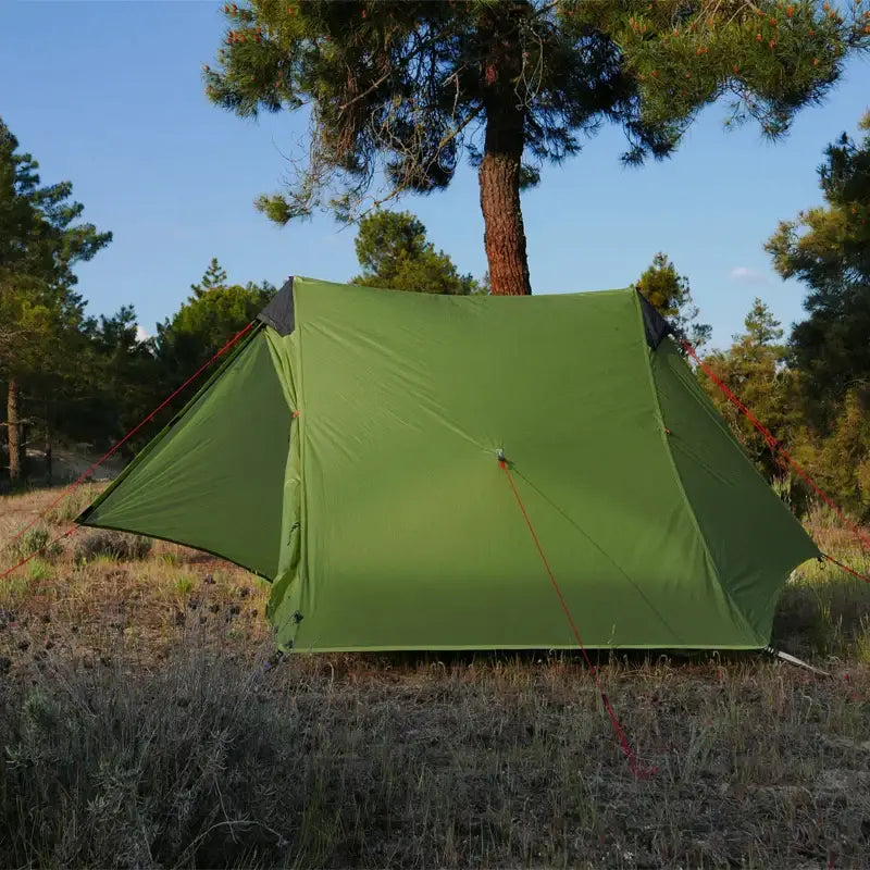 a green tent in the woods
