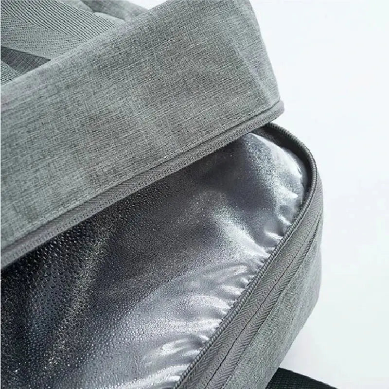 the back of a grey backpack with a zipper