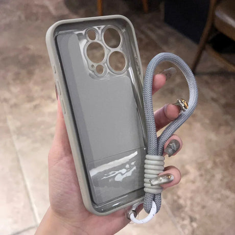 A grey iPhone case with a matching lanyard.