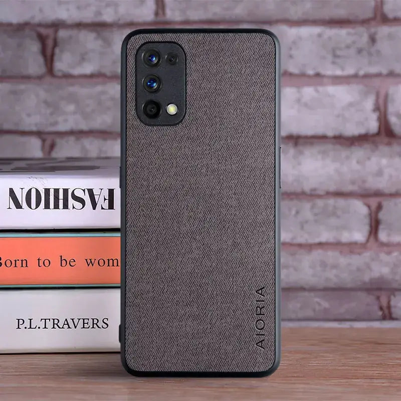 the back of a grey iphone case sitting on top of a stack of books