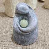 a small stone with a green stone inside