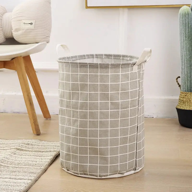 a grey and white laundry basket with a white grid pattern