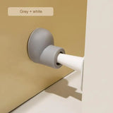 a white door handle on a beige door