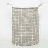 a grey and white laundry basket with a grid pattern
