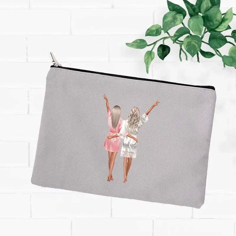 a grey zipper pouch with a girl in a pink dress