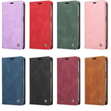 A grid of eight flip-style phone cases in various colors, each featuring a textured finish and a small metallic button detail.