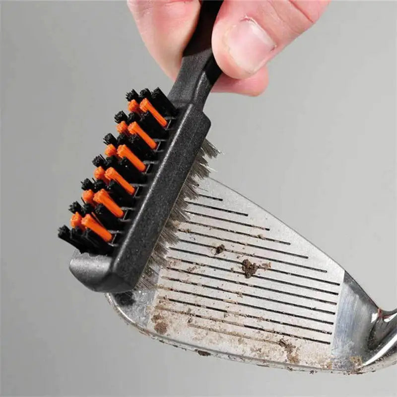 someone is holding a brush with a black handle and orange tips