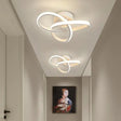 a hallway with a white light fixture and a painting on the wall