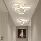 A hallway with a white light fixture and a painting on the wall