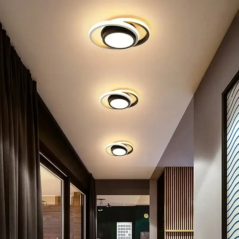 a hallway with a wooden floor and two lights