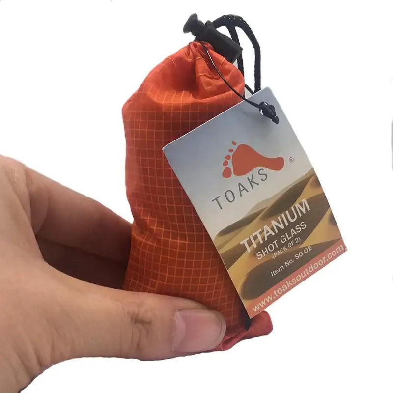 a hand holding a bag of tea