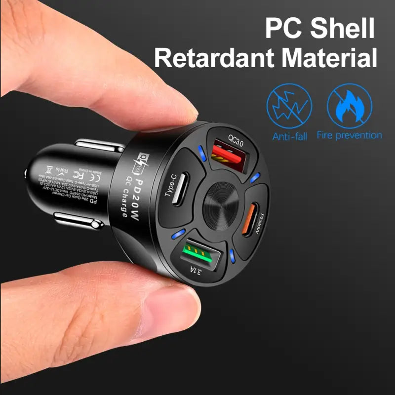 a hand holding a black and blue car charger