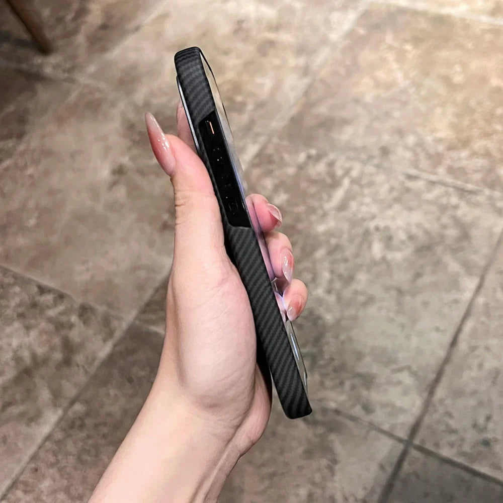 Hand holding a black carbon fiber phone case.