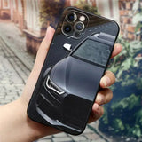 a hand holding a black iphone case with a car image on it
