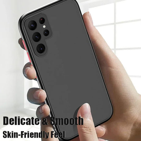 a hand holding a black iphone case