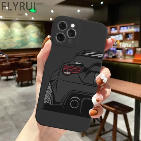 A hand holding a black iphone case with a car design