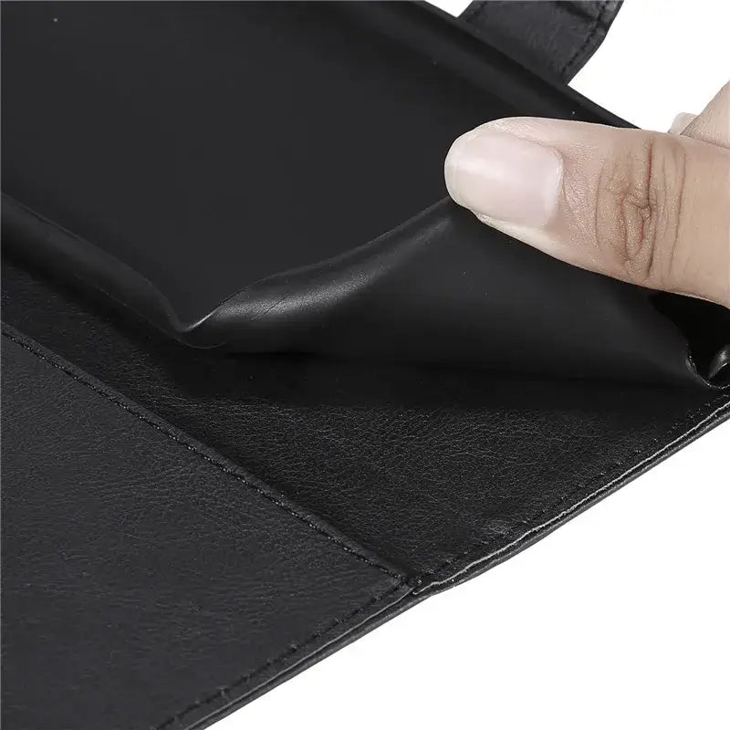 A hand holding a black leather wallet