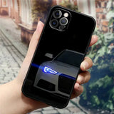 a hand holding a black phone case with a blue light on it
