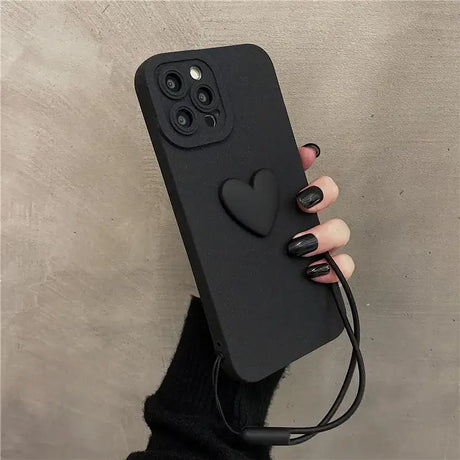 A hand holding a black phone case with a black cable