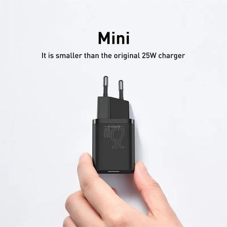 a hand holding a black usb charger
